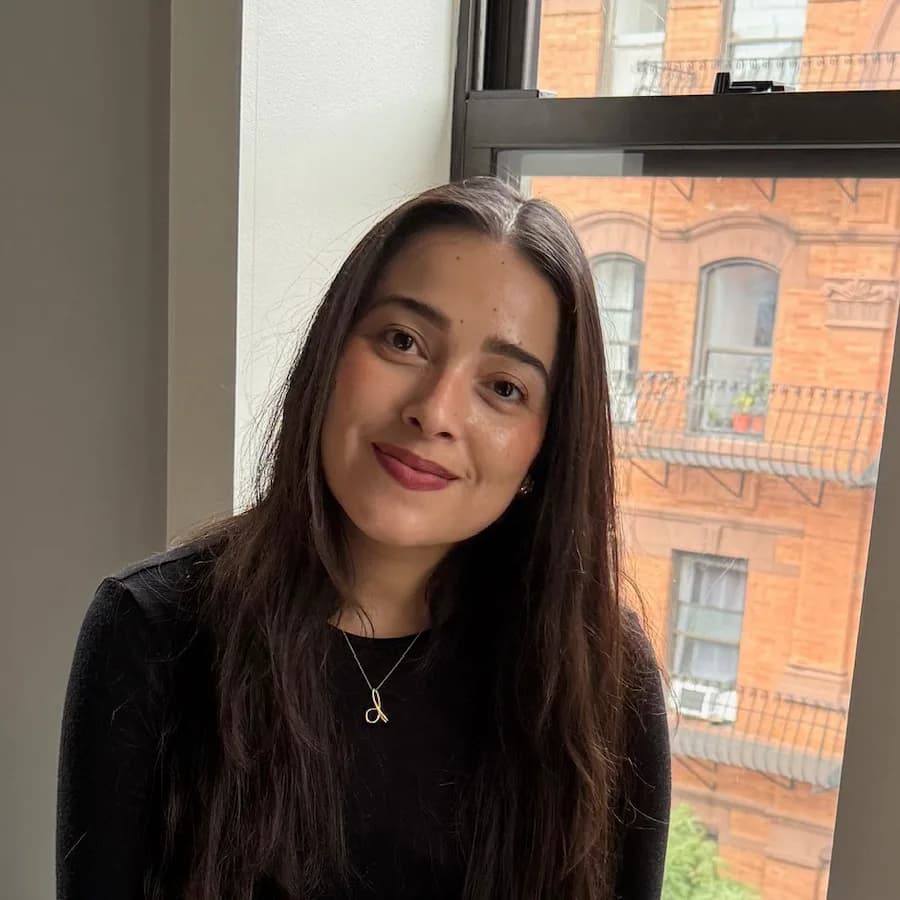 Daisy, who builds renasca, by a window in New York.
